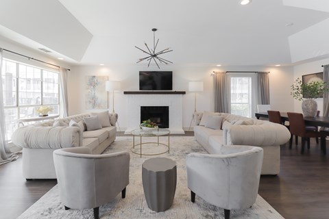 A modern living room with a fireplace and a television.
