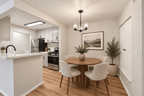 A modern kitchen with a dining table and chairs.