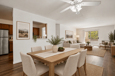 A modern dining room with a wooden table and chairs.