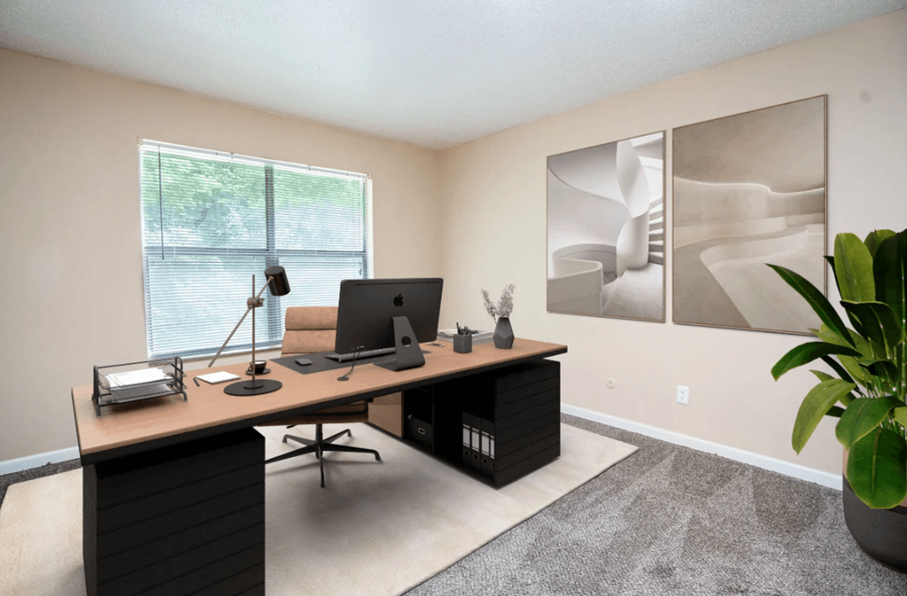 A home office with a desk, chair, and computer setup.