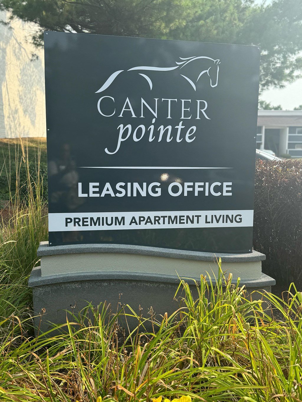a sign for the leasing office of canter pointe in front of the grass