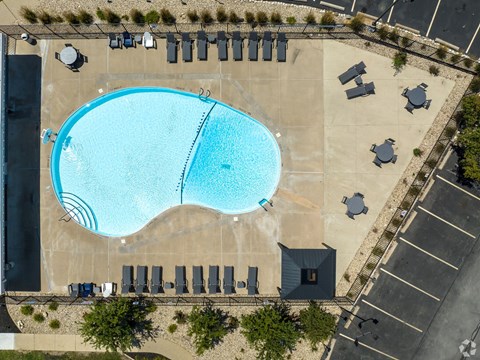 An aerial view of a swimming pool surrounded by lounge chairs.