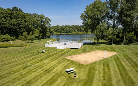 A baseball field with a lake in the background.