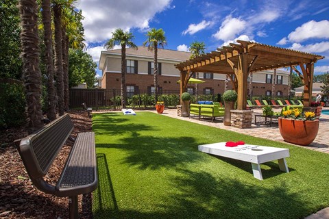 a yard with a picnic table and a swing