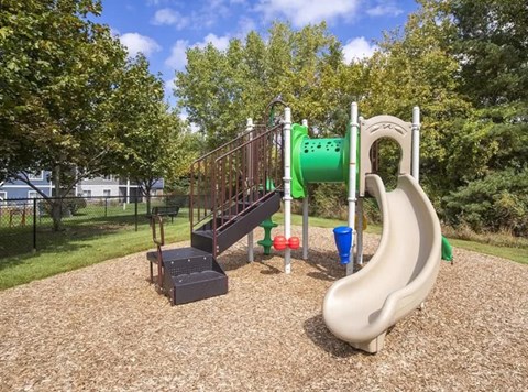 a playground with a slide at a park