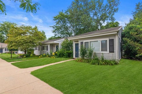 a white house with a yard and a sidewalk