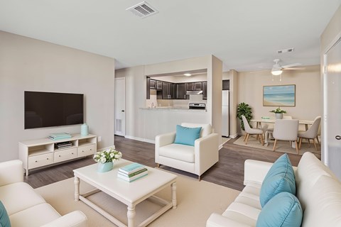 A living room with a white couch and a coffee table.