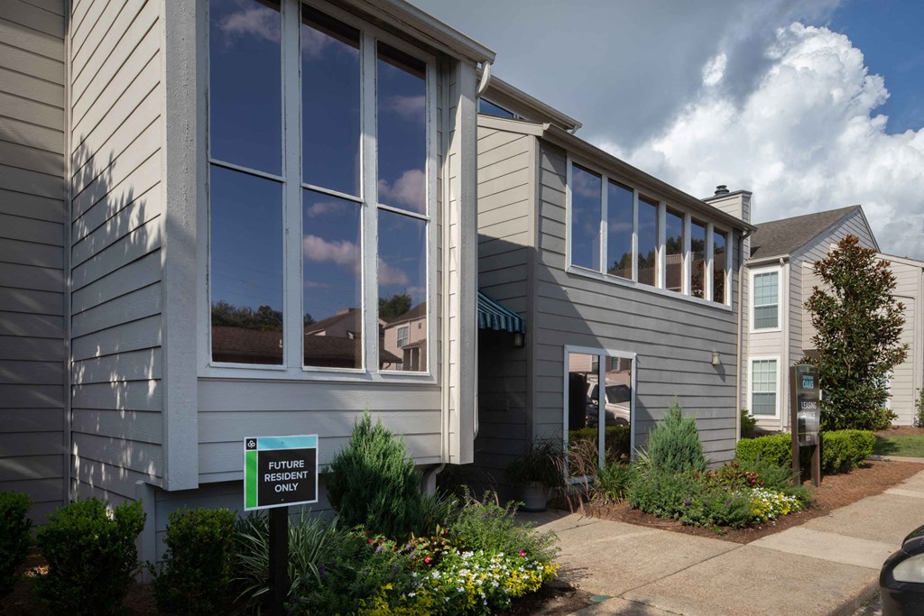 a house with a green sign in front of it
