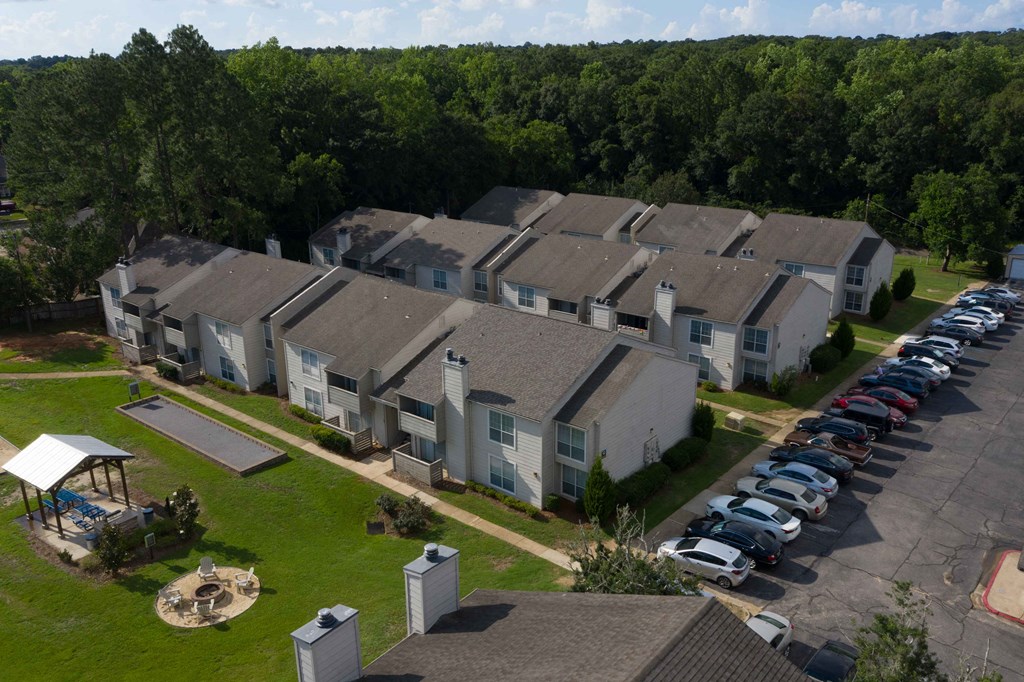 an aerial view of a row of houses with cars parked in front of them