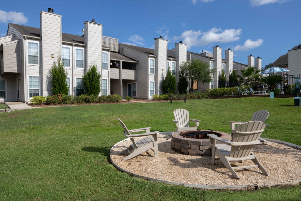 our apartments showcase a fire pit in the middle of our grassy area