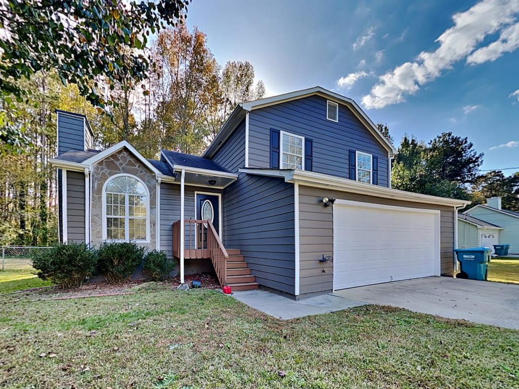 a blue house with a white garage door