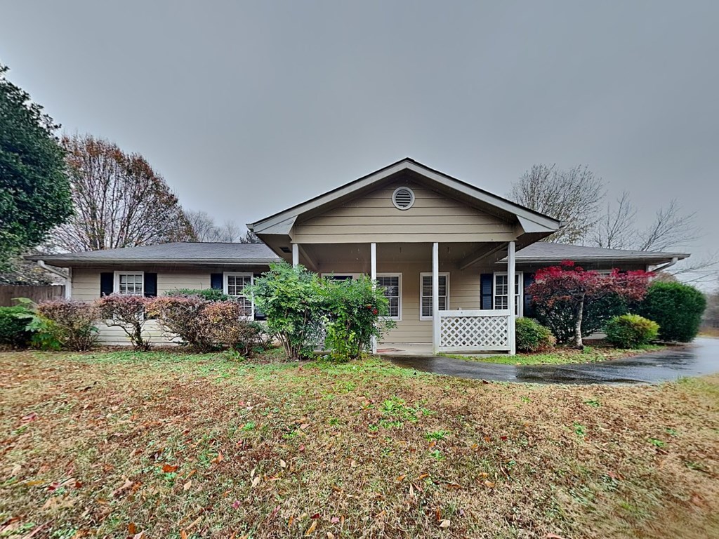 a house with a yard and a gray sky