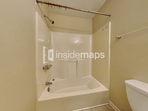 a bathroom with a tub and a toilet