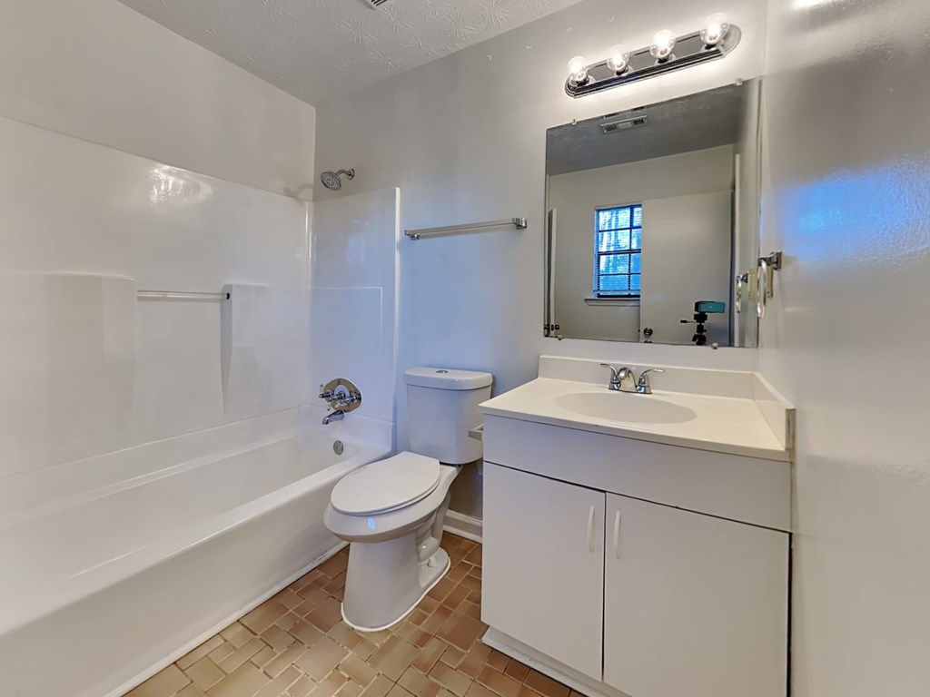 a bathroom with a sink toilet and a bath tub