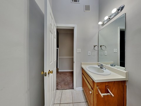 an empty bathroom with a sink and a mirror