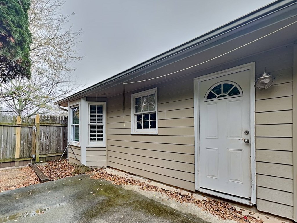 a home with a white door on the side of a house
