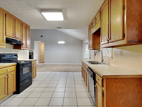 a kitchen with wooden cabinets and a black stove
