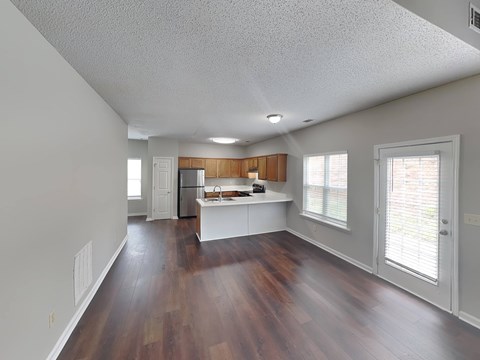 A kitchen with white cabinets and a wooden island.