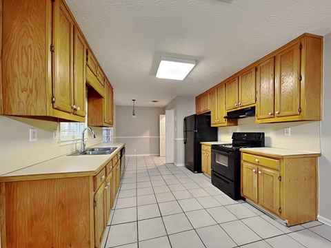 a kitchen with wooden cabinets and black appliances