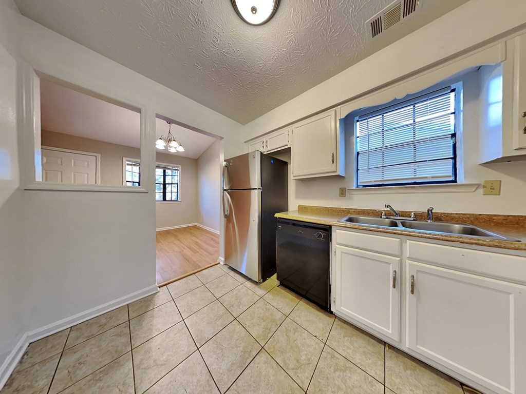 a kitchen with a sink and a refrigerator