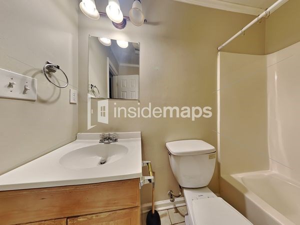 a bathroom with a sink toilet and a mirror