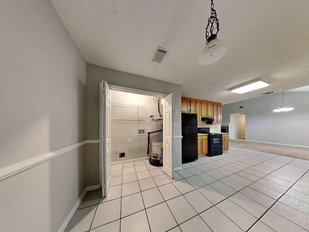 a kitchen and a living room with a tile floor