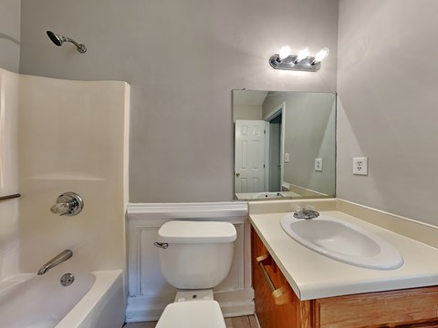 a bathroom with a sink toilet and a mirror