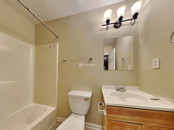 a bathroom with a sink toilet and a mirror