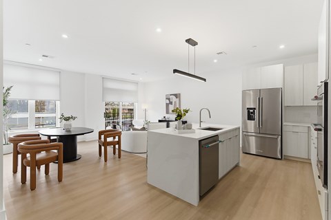 A modern kitchen with a dining table and chairs.