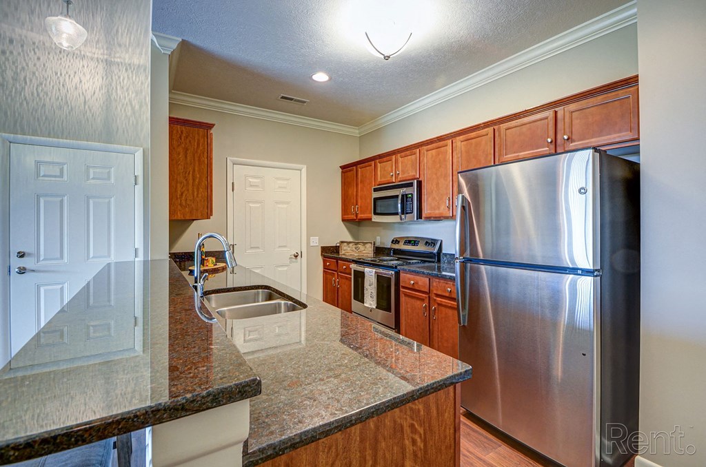 a kitchen with granite countertops and stainless steel appliances