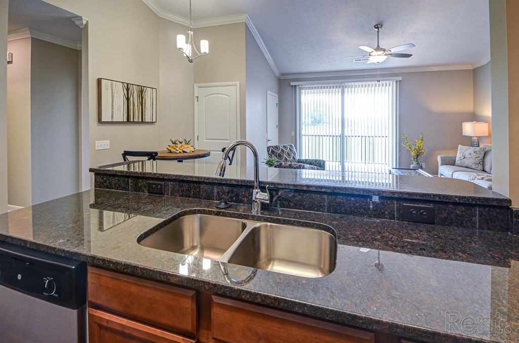a kitchen with granite countertops and a large window