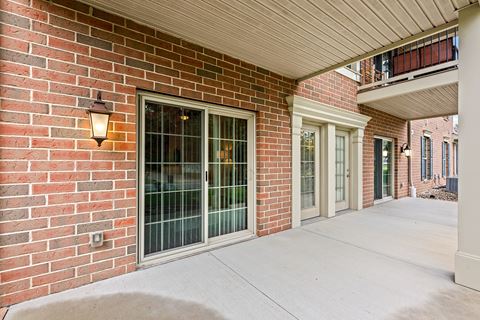 the entrance to a brick building with glass doors