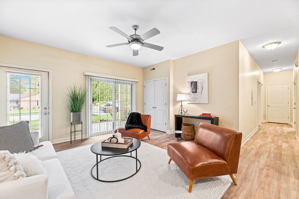 a living room with furniture and a ceiling fan