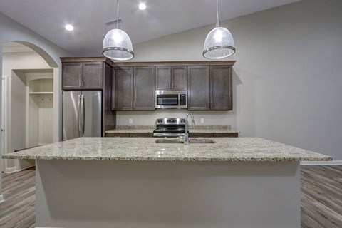 a kitchen with a counter top and a refrigerator