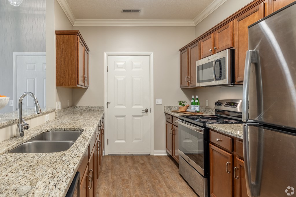 a kitchen with granite counter tops and stainless steel appliances