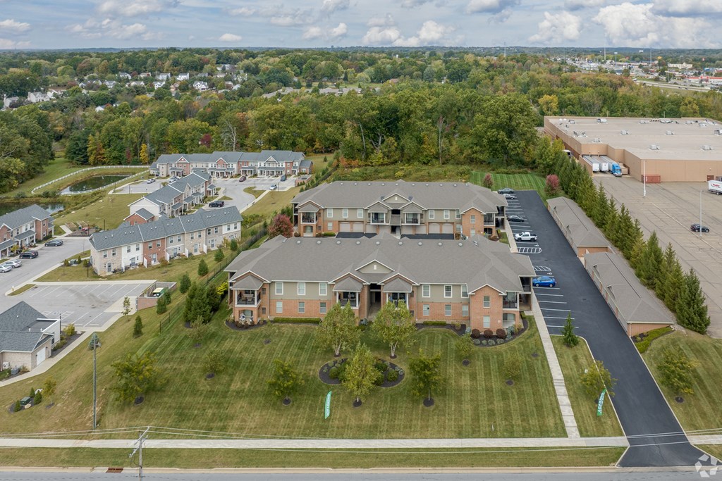 an aerial view of a group of houses in a parking lot