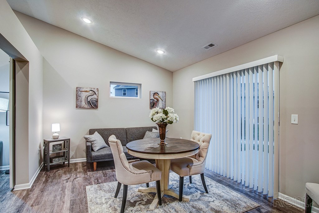 a living room with a couch and a table with chairs