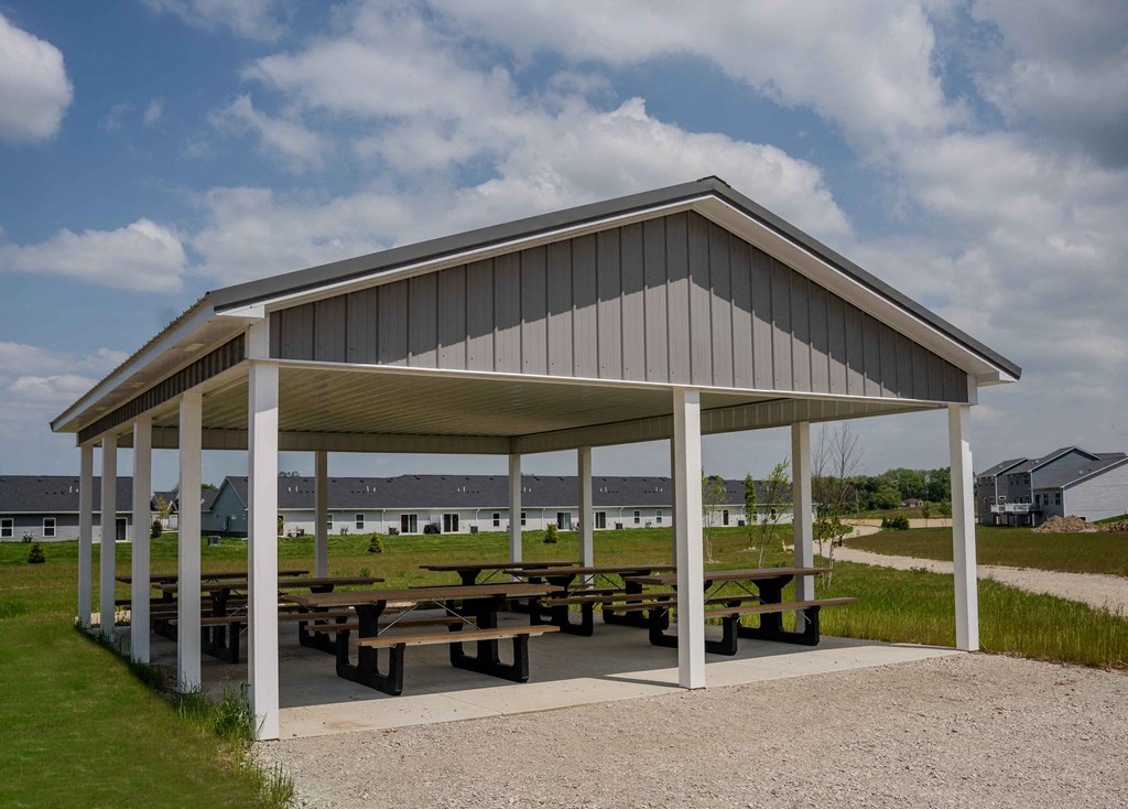 a pavilion with picnic tables under it
