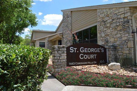 A sign that says St. George's Court in front of a building.