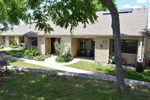 A tree is in front of a house.