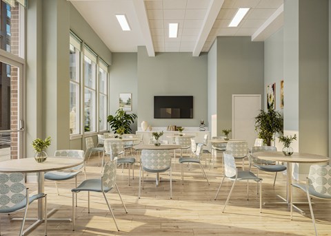 A room with a white table and chairs with a green plant on the table at Oskamp Flats Apartments, Cincinnati, Ohio