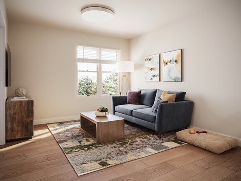 A living room with a grey couch, a wooden side table, and a rug. at Bretton Woods II Apartments, Ohio, 43231