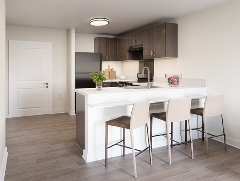 A kitchen with a white island and brown chairs. at Divinity Landing Apartments, Ohio