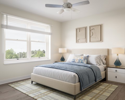 A bedroom with a large bed and a ceiling fan. at Divinity Landing Apartments, Macedonia, OH, 44056
