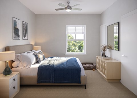 A bedroom with a bed, nightstand, and a window with blinds.