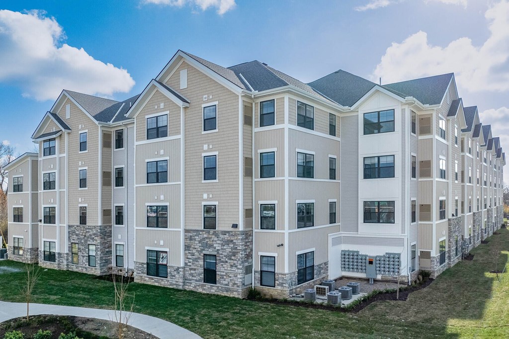 A row of modern apartment buildings with a clear blue sky above.