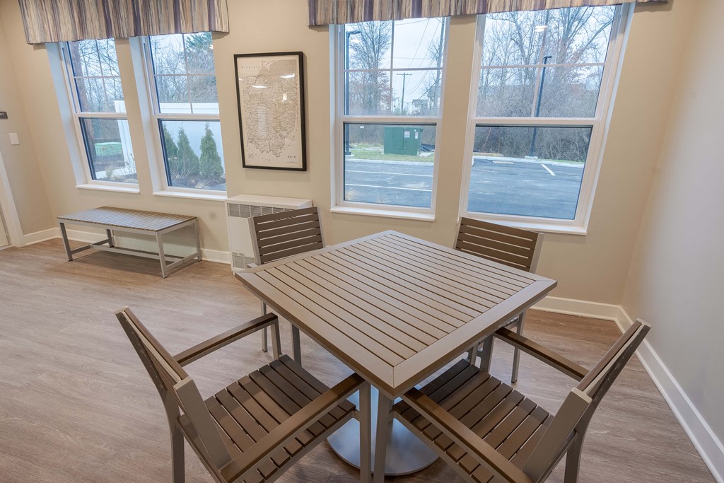 A dining room with a table and chairs.
