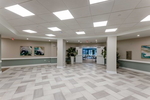 A spacious office lobby with a checkered floor and white walls.