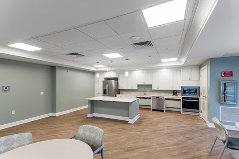 A kitchen area with a dining table and chairs.