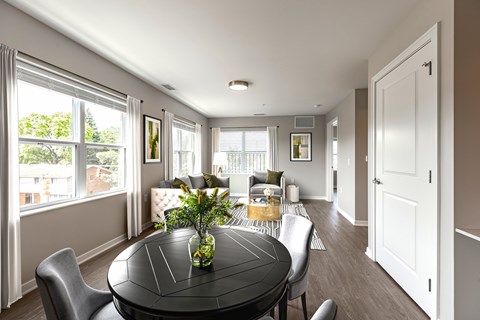 A dining room with a table and chairs.